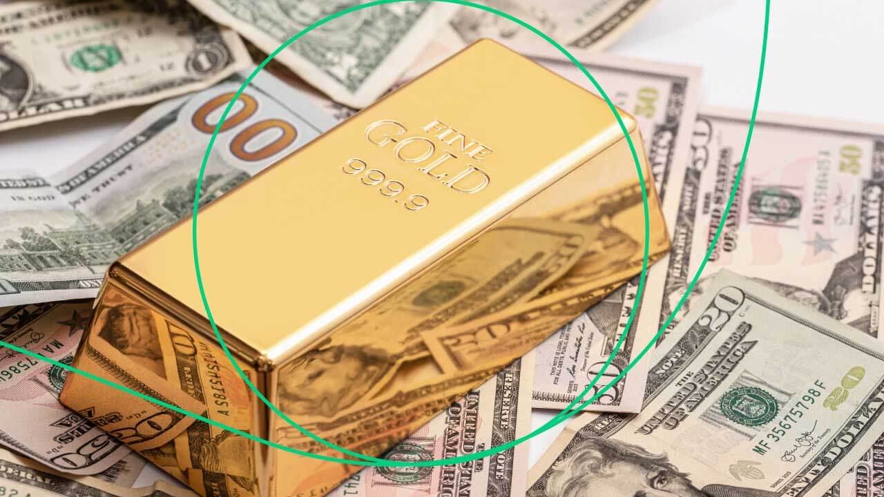 A gold bar labeled "999.9 Fine Gold" placed on top of scattered US dollar bills, representing trading gold CFDs and key insights investors need to know.