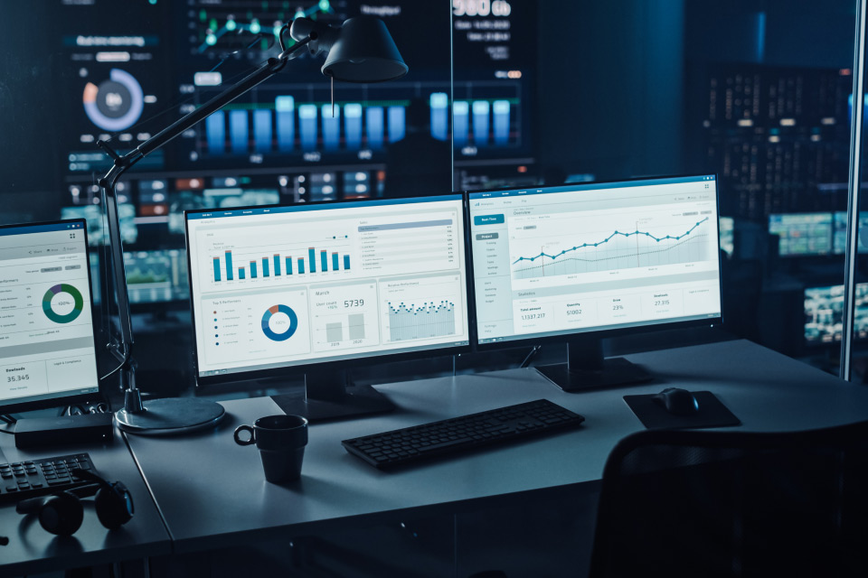 trading workstation with multiple monitors displaying financial charts