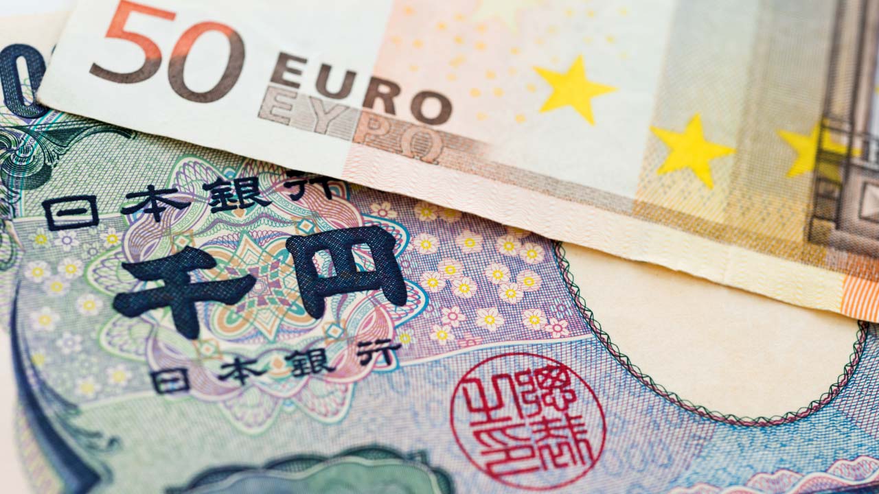 Close-up image of two currency banknotes: a €50 Euro note partially overlaying a ¥1000 Japanese Yen note.