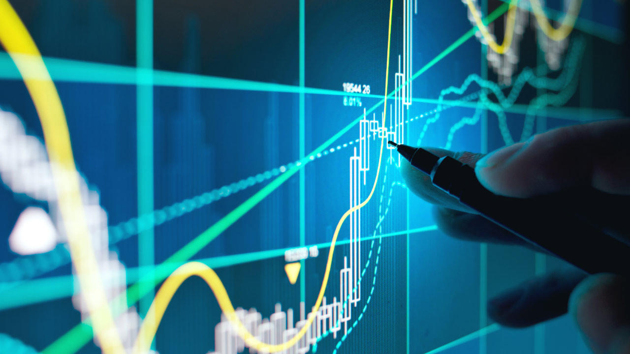 Speed Resistance Lines displayed on a financial chart with a hand holding a pen, analyzing market trends and potential support and resistance levels.