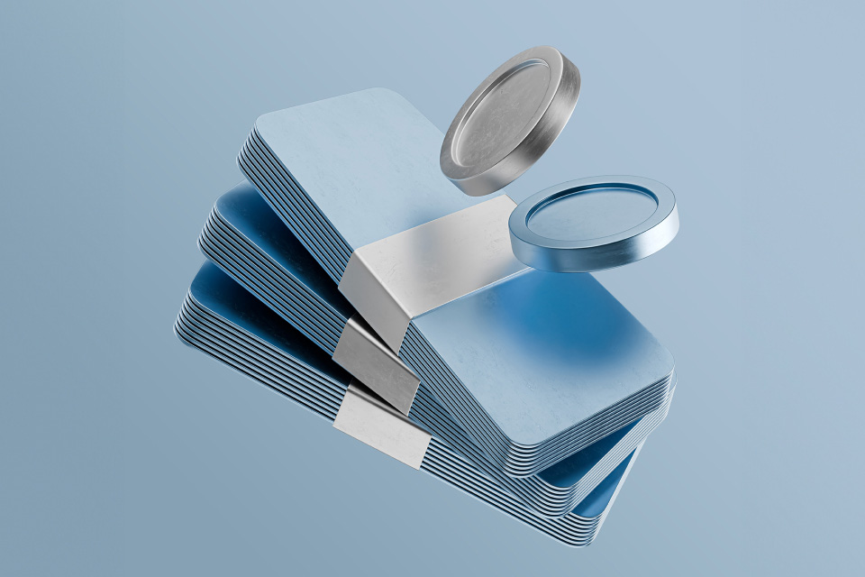Stacked metallic blue trading cards with floating coins, illustrating the concept of what corporate bonds are.