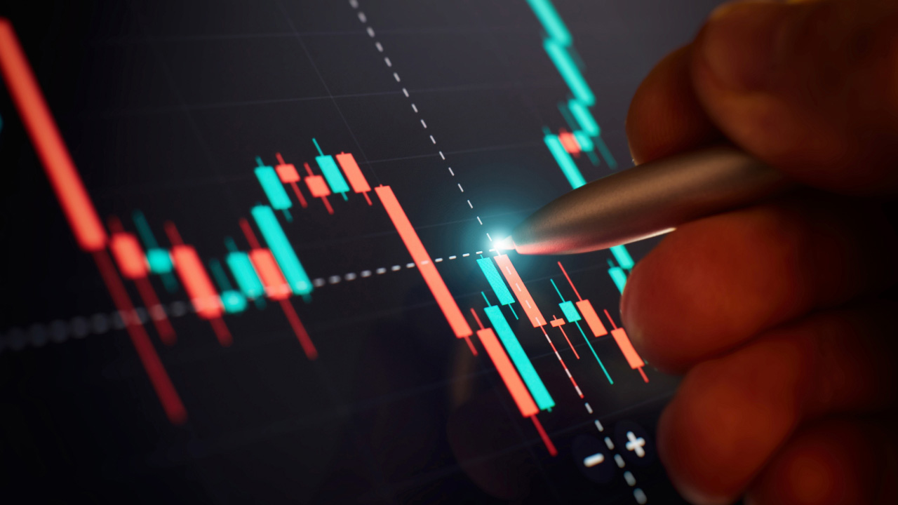 Risks Associated With Candlestick Chart Patterns – A trader analyzing a digital candlestick chart with a stylus, highlighting potential risks in technical analysis.