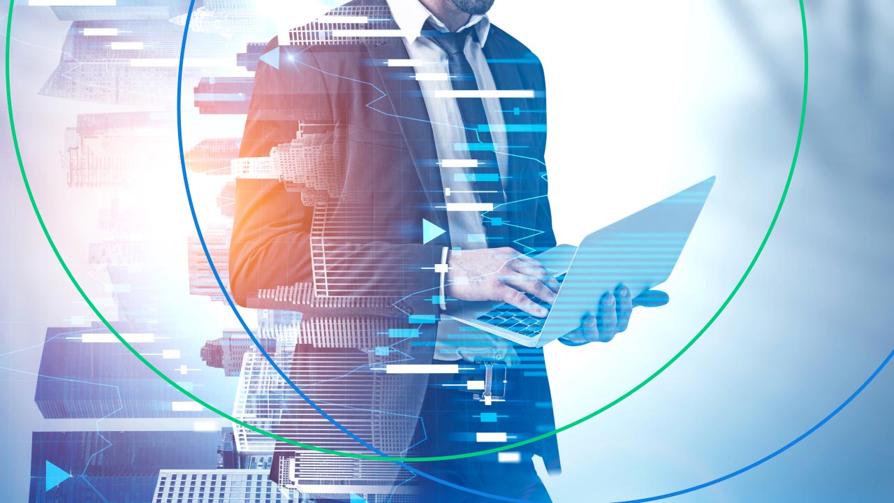 a businessman in a suit using a laptop, with overlaid digital charts 