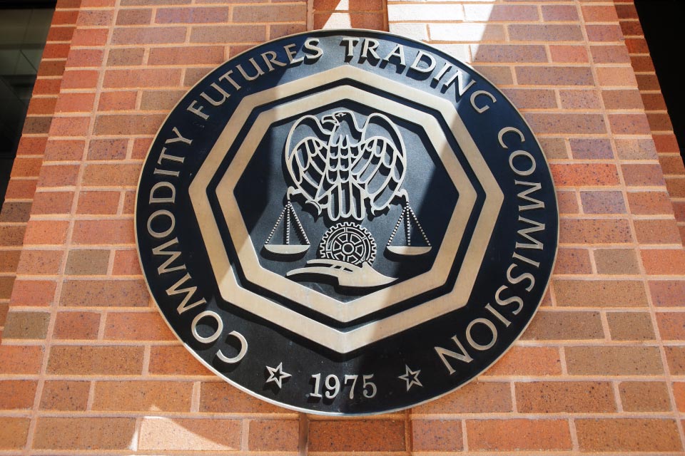 A sign of the Commodity Futures Trading Commission (CFTC) on a brick wall, symbolizing forex market regulation and oversight by financial authorities.