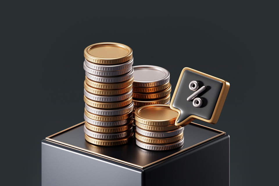 Stacked coins with a percentage symbol icon, symbolizing interest rates, illustrating where interest rates might go in 2025.