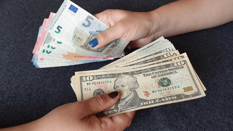 2 hands showing the exchange of euro and US dollars
