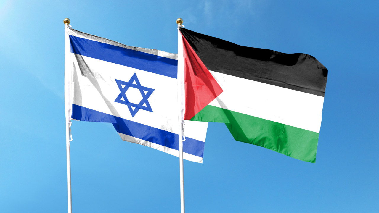 Israeli and Palestinian flags side by side against a clear blue sky, symbolizing geopolitical tension and its impact on forex markets.