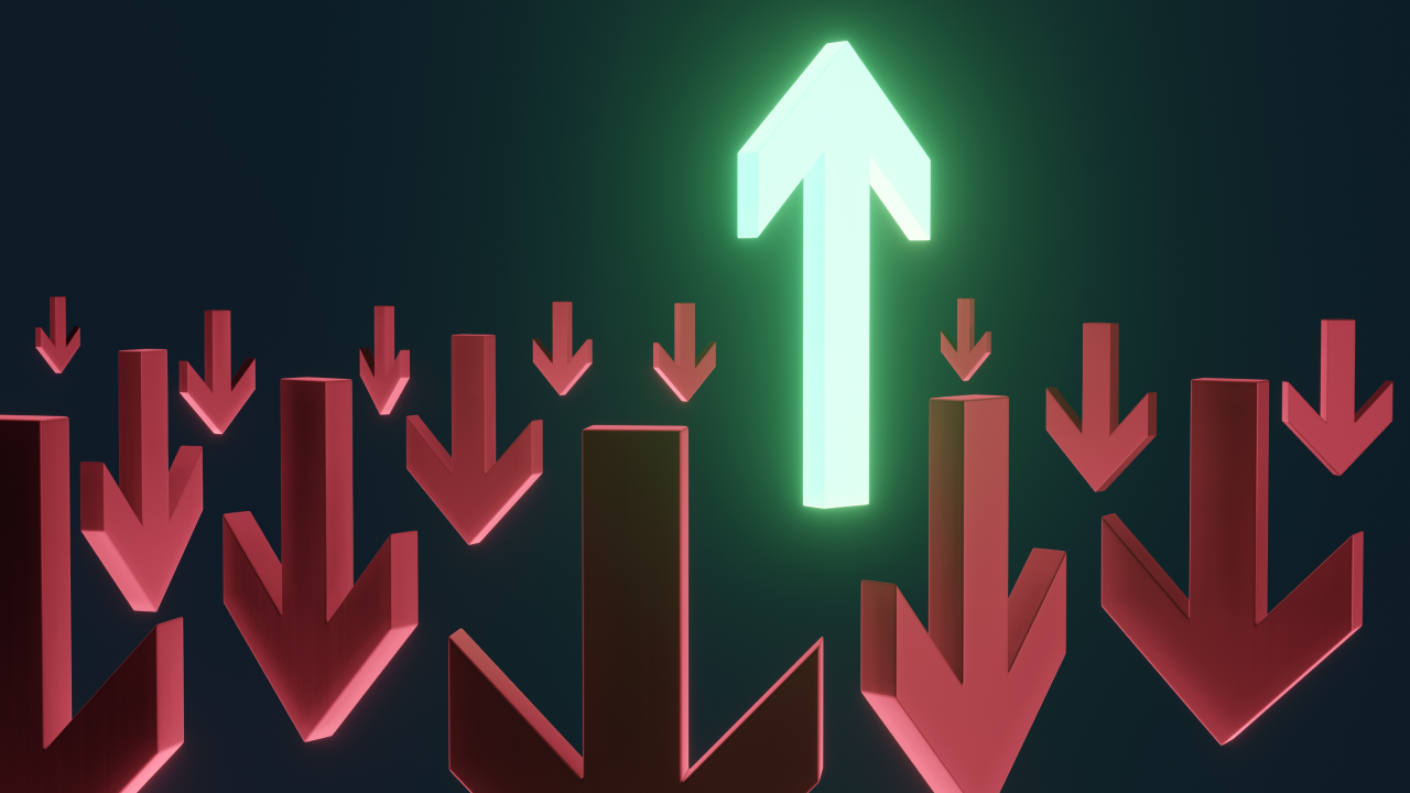 Trading Biases vs Predictions: What's The Difference?, illustrated by a glowing green upward arrow standing out among many red downward arrows, symbolizing the difference between trading biases and market predictions.