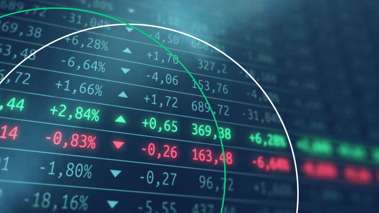 Short Selling Stocks: What does Shorting a Stock Mean?, illustrated by stocks displayed on a screen.