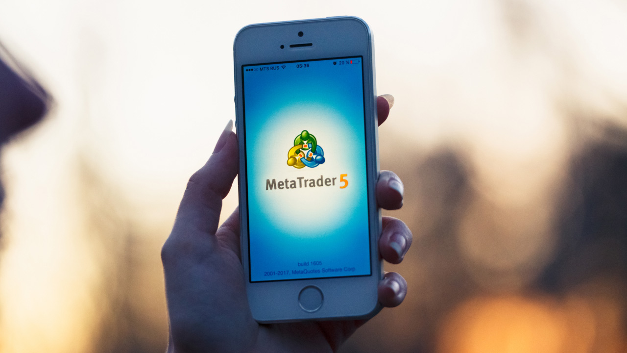 An image of the MetaTrader 5 mobile app interface with the text "MetaTrader 5" and "BUSINESS" displayed. The graphic provides a guide on how to use the MetaTrader 5 mobile app for trading, highlighting its features and functionality for business and financial activities.
