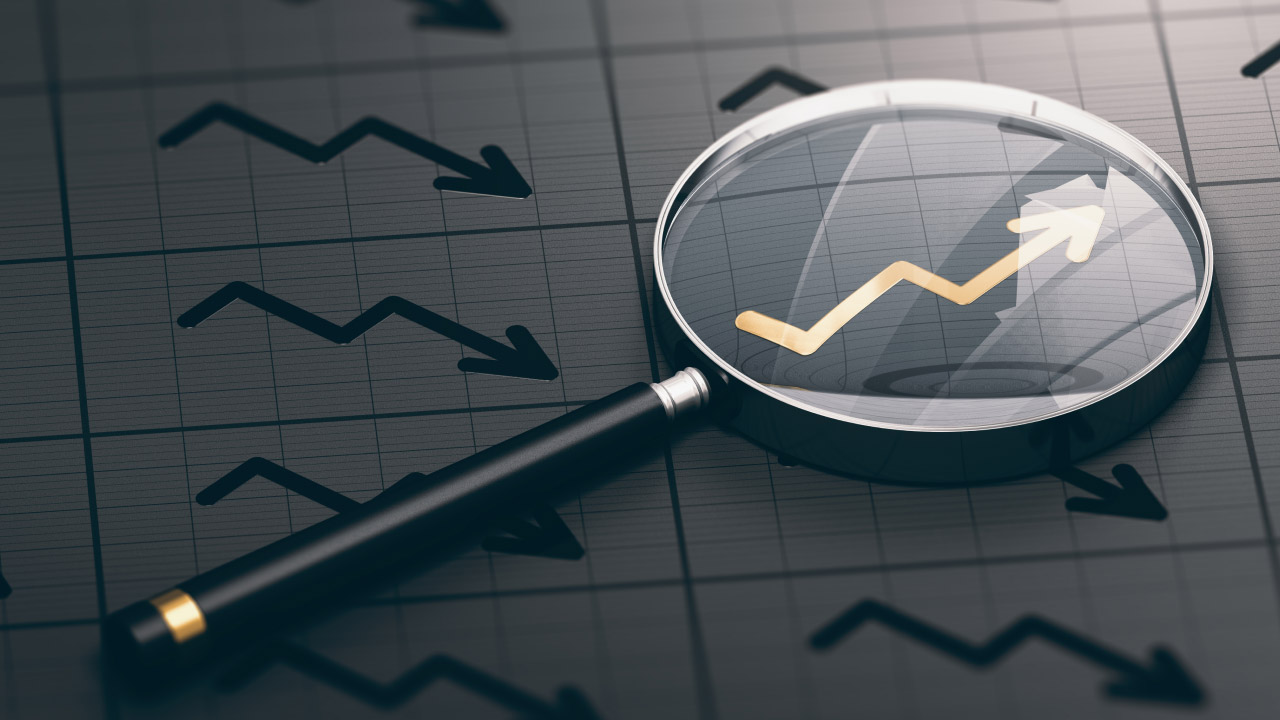 A magnifying glass placed over a chart with a yellow arrow, illustrating the concept of the Consumer Sentiment Index.
