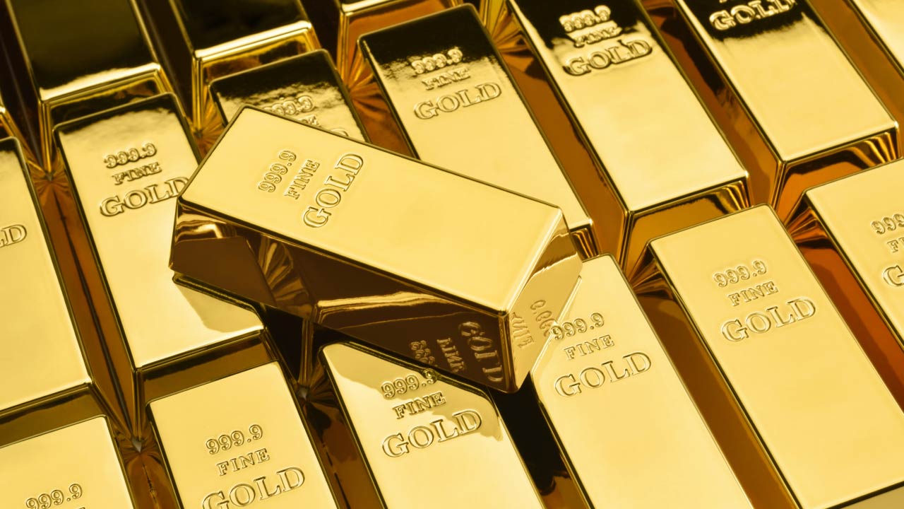 Stacked gold bars with "999.9 FINE GOLD" inscriptions