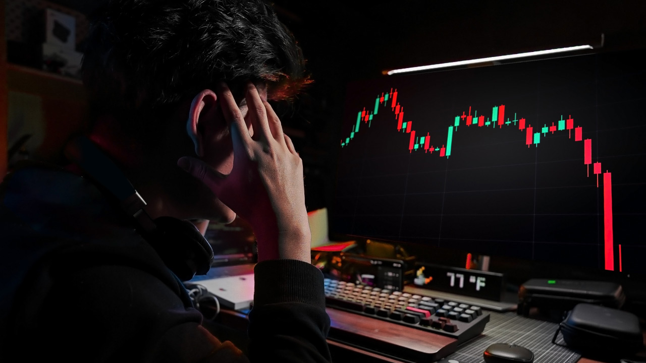 trader reacting to sudden forex market crash with sharp candlestick drop on trading platform