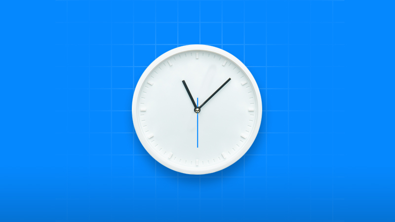 Minimalist white wall clock showing the time against a blue grid background.
