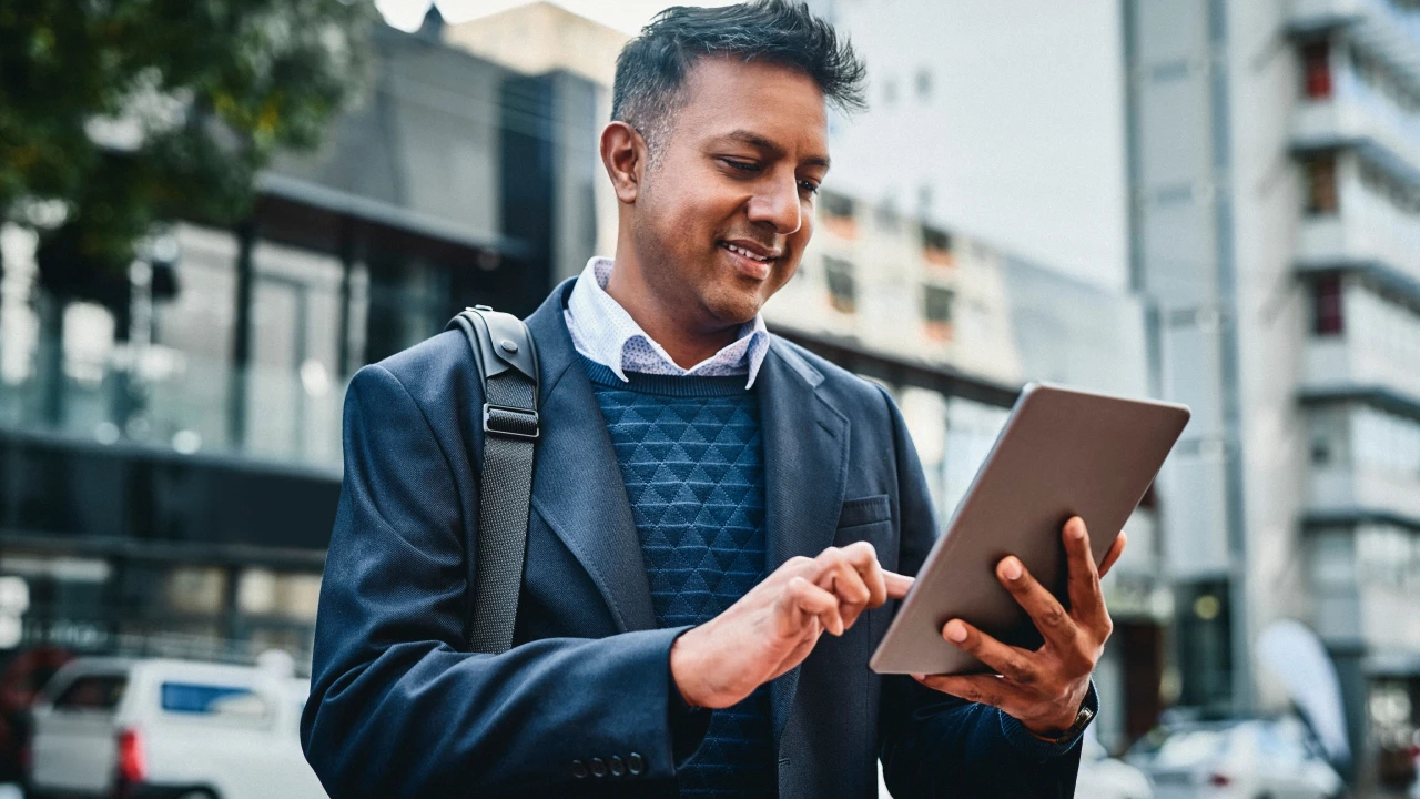 Man holding a tablet displaying a forex profit calculator interface for measuring trade profits and losses.