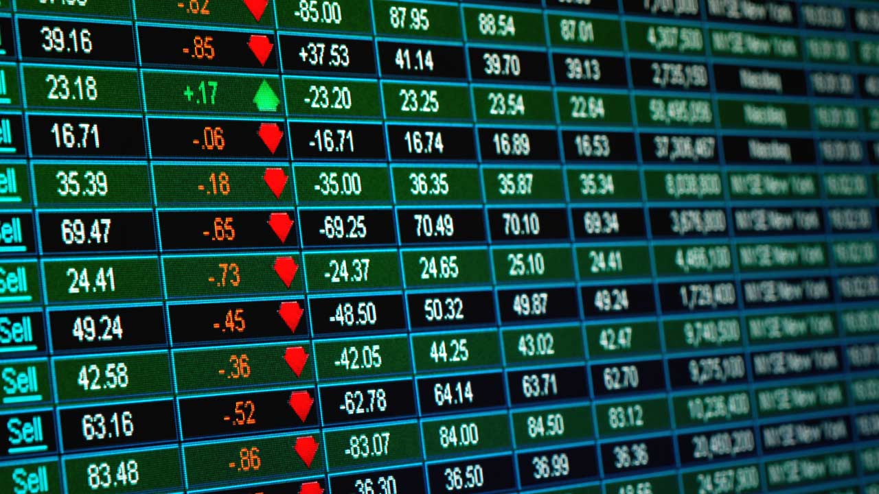 Popular Stocks to Start Your 2024 Out Strong, illustrated by a monitor showing stock exchange data.