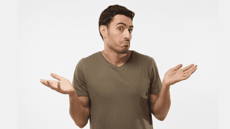 man shrugging his arms