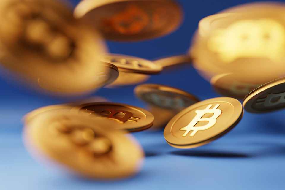Bitcoin Price Prediction for 2025: A dynamic image of golden Bitcoin coins in motion, symbolizing the volatility and future potential of cryptocurrency.