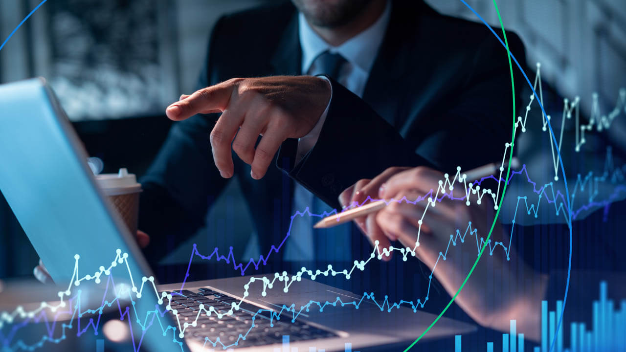 Two business professionals analyzing forex market data on a laptop, with financial charts and graphs overlaid, representing top forex forecasting techniques.