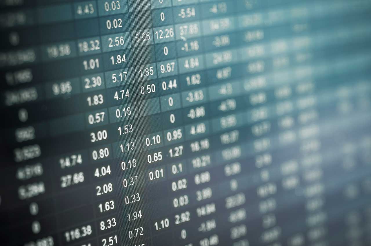 The Nitty-Gritty of Risk Management, illustrated by a close-up view of a digital screen displaying financial data and numerical values in rows and columns.