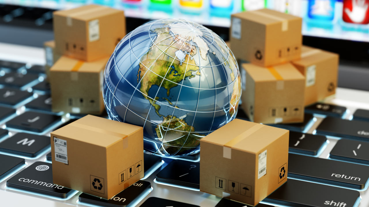 What is the Retail Sales Index? A globe surrounded by cardboard boxes on a keyboard, symbolizing global e-commerce and retail trade performance.