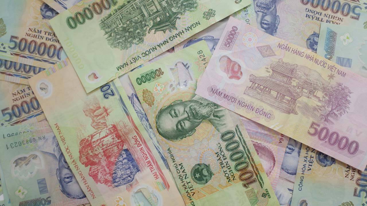 a scattered collection of Vietnamese đồng banknotes in various denominations