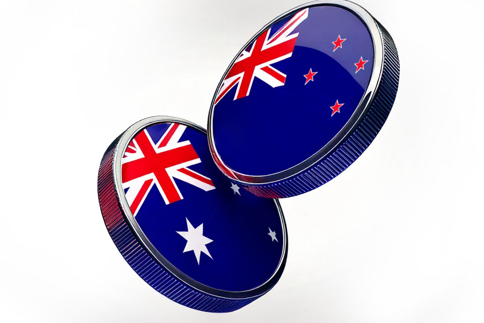 two metallic coins featuring the Australian and New Zealand flags