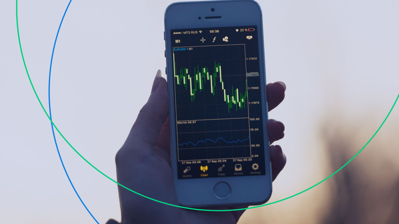 a person holding a smartphone displaying a forex trading chart for the EUR/USD currency pair