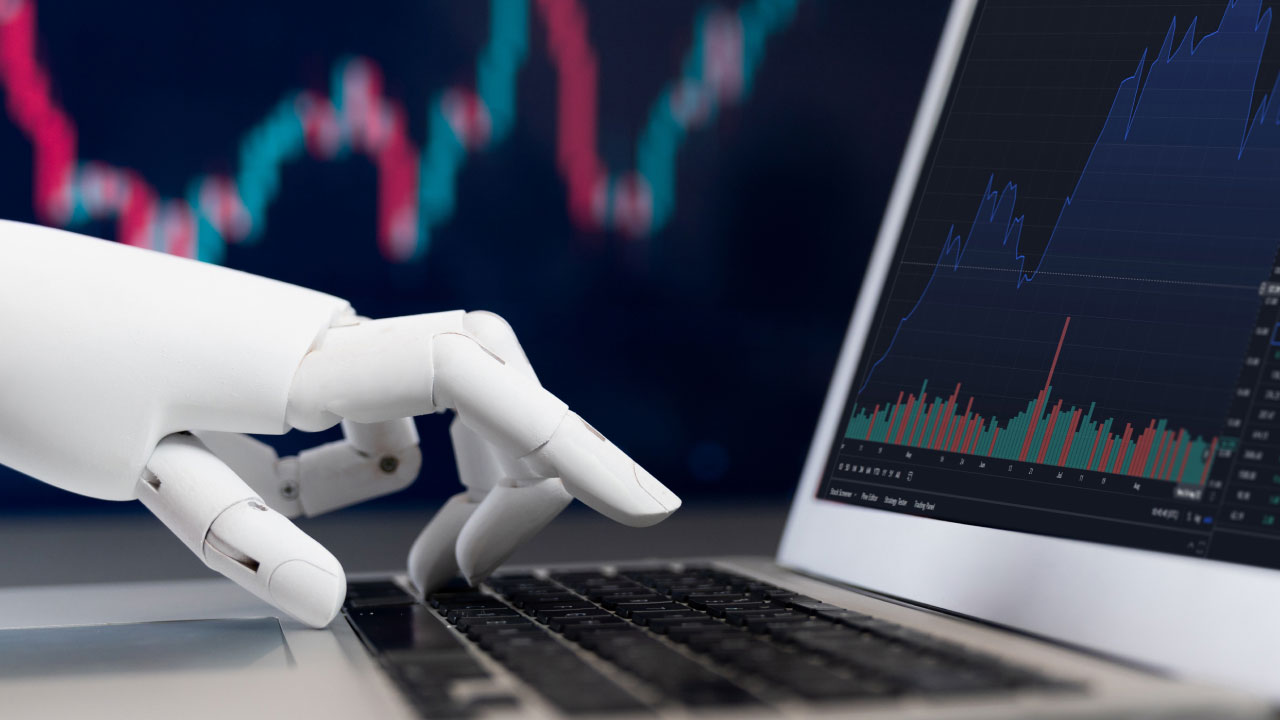 a robotic hand typing on a laptop keyboard with a stock market chart on the screen