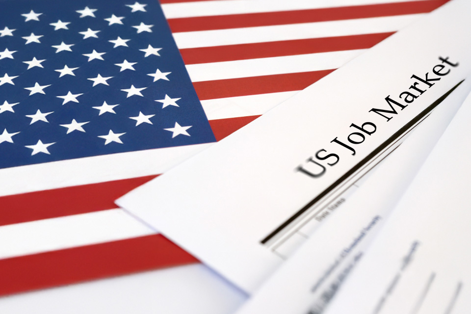 US job market report with an American flag in the background