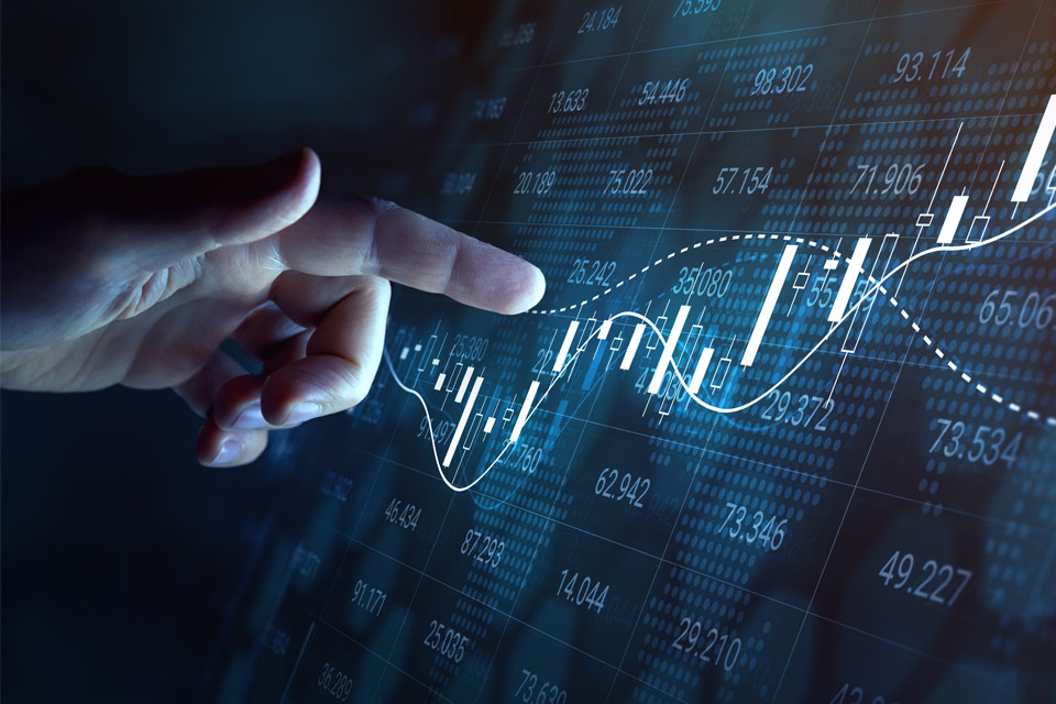 Hand pointing at a digital stock market chart displaying candlesticks and moving averages, symbolizing market breadth indicators.